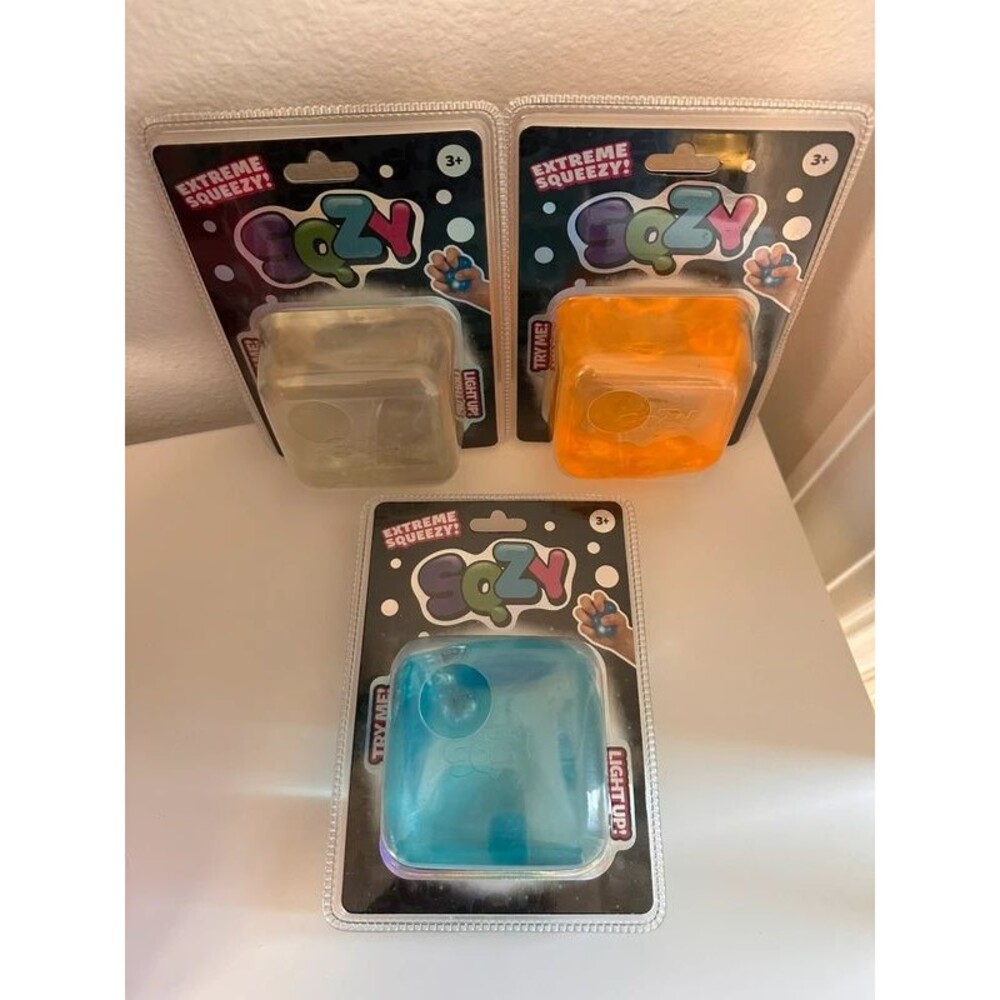 Sunny Days SQZY Light Up Squishy Cubes - Blue, Orange, & Clear